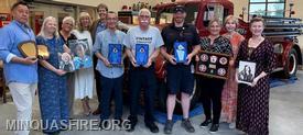 The photo features from left to right: Rob Kram, Laurie Usher, Rose MascherinoCiarlone, JoAnn Yaworski-Usher, Glenn Usher, Stephen P. Miller (award recipient), Michael Miller (award recipient), Tyler Deck (award recipient), Heather Kram, Donna Usher, and Shawna Usher.