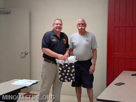 President Joel Swisher presents a gift from the membership to Past Chief Michael Miller.